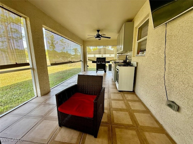 sunroom with ceiling fan and a healthy amount of sunlight