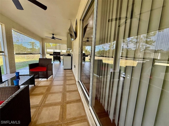 view of patio / terrace with a balcony and ceiling fan