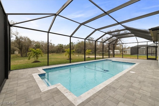 view of swimming pool with a lanai, a lawn, and a patio