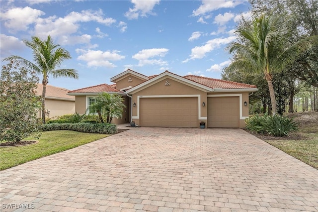 3200 Magnolia Landing Ln, North Fort Myers, FL 33917 - mediterranean / spanish house with stucco siding, decorative driveway, a garage, a tiled roof, and a front yard