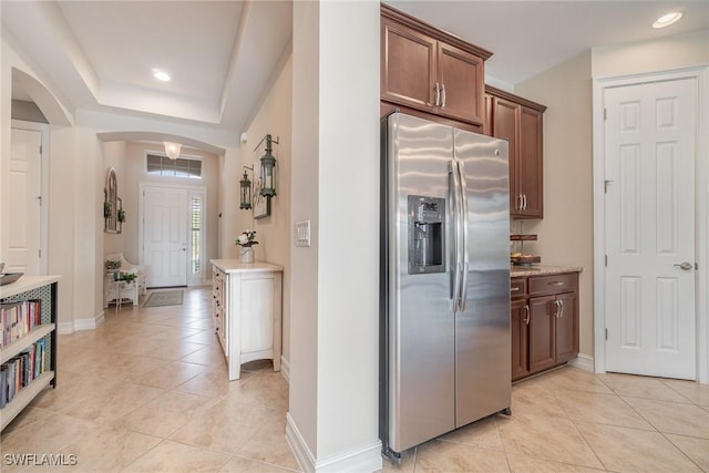 3200 Magnolia Landing Ln, North Fort Myers, FL 33917 - kitchen featuring stainless steel fridge, arched walkways, light tile patterned floors, and recessed lighting