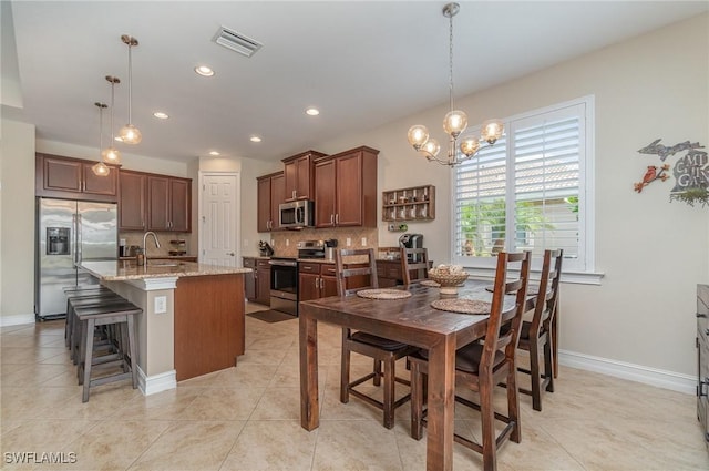 dining room featuring light tile patterned flooring and sink