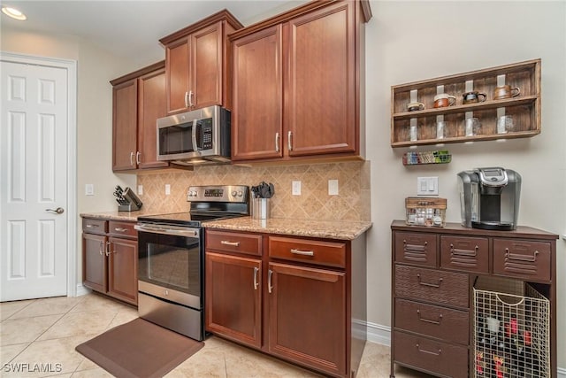 3200 Magnolia Landing Ln, North Fort Myers, FL 33917 - kitchen featuring appliances with stainless steel finishes, tasteful backsplash, light stone countertops, and recessed lighting