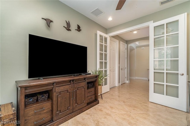 living room featuring french doors, ceiling fan, and light tile patterned flooring