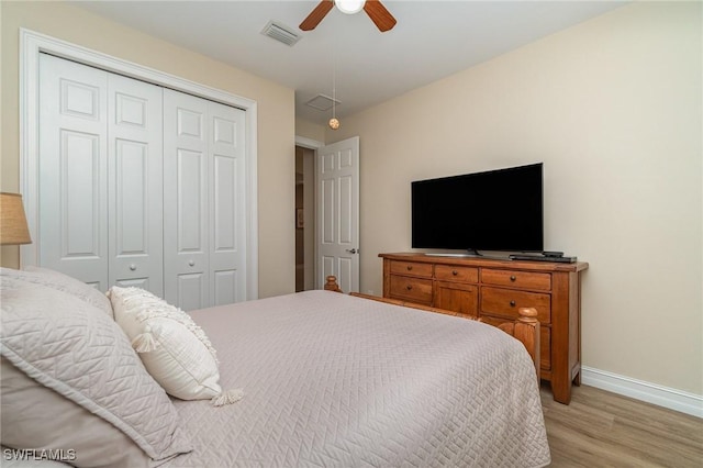 bedroom with a closet, ceiling fan, and light wood-type flooring