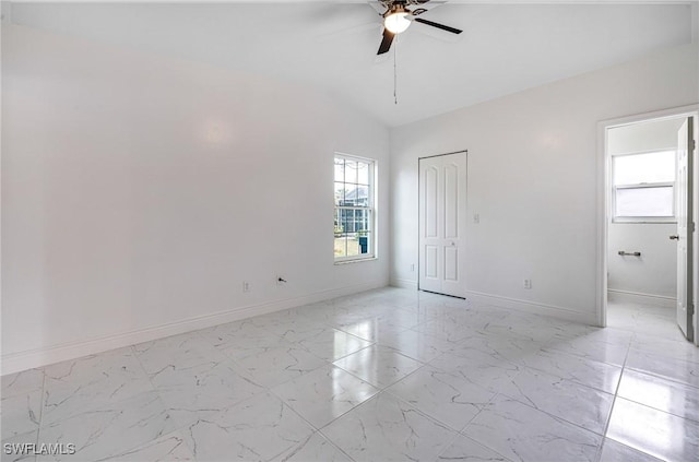 unfurnished room with ceiling fan and vaulted ceiling