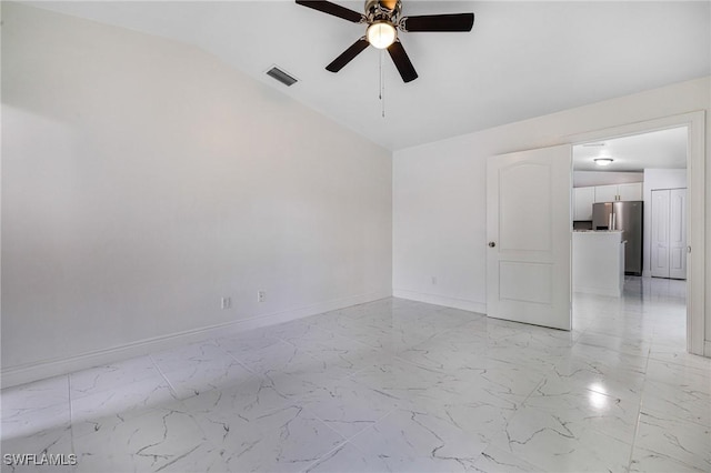 spare room featuring ceiling fan and vaulted ceiling