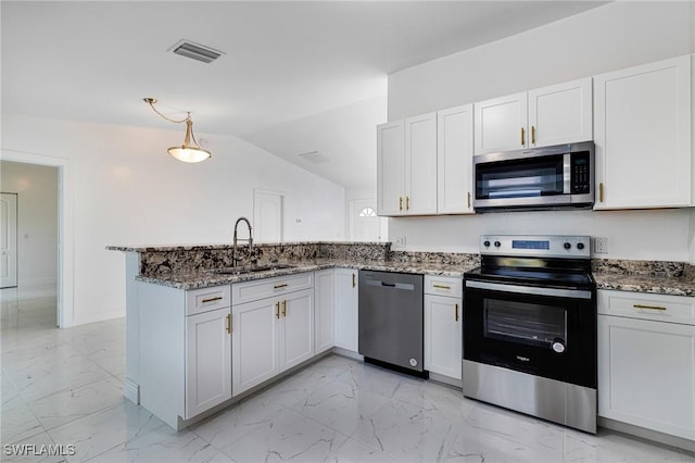 kitchen with white cabinetry, sink, stainless steel appliances, and kitchen peninsula