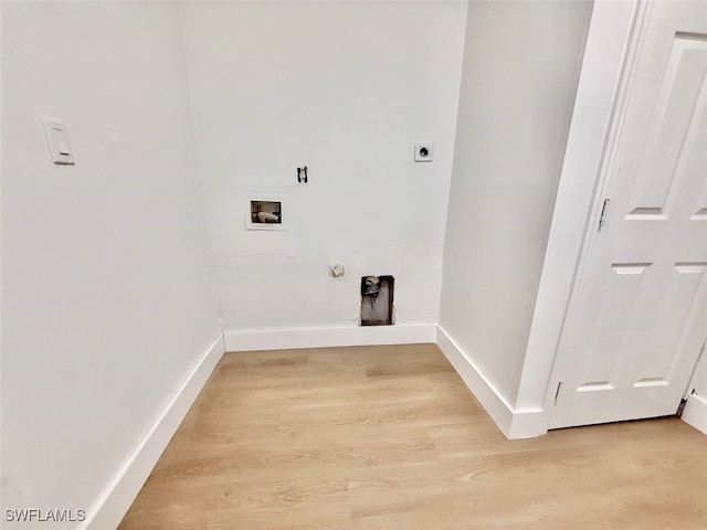 washroom featuring electric dryer hookup, hardwood / wood-style floors, hookup for a washing machine, and hookup for a gas dryer