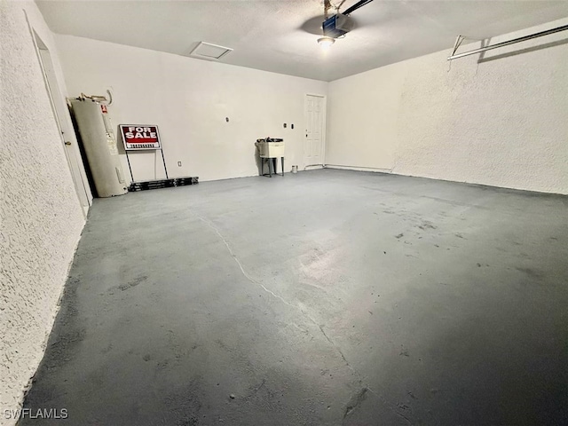 garage featuring electric water heater and a garage door opener