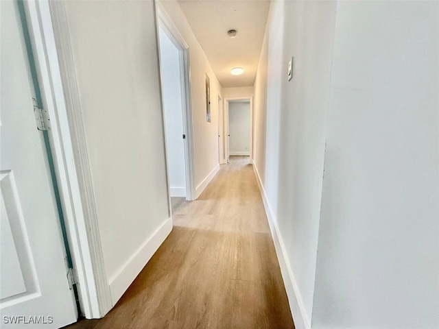 corridor featuring light hardwood / wood-style floors