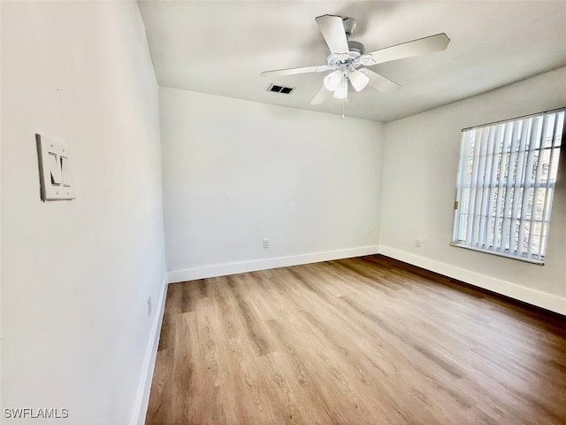 empty room featuring light wood-type flooring and ceiling fan