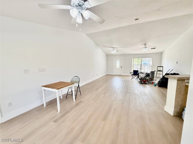 misc room with lofted ceiling and light hardwood / wood-style flooring