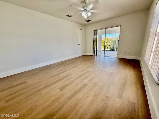 empty room featuring ceiling fan and light hardwood / wood-style flooring