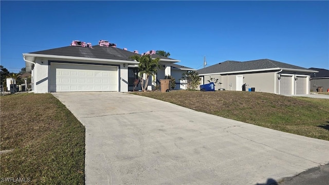 ranch-style house with a garage and a front yard