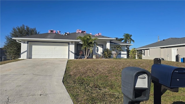 single story home featuring a garage and a front yard