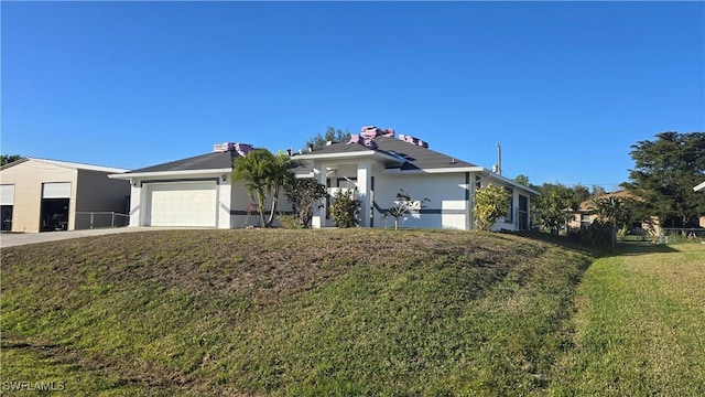 ranch-style house with a garage and a front lawn