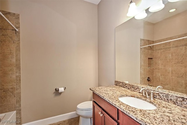 full bathroom featuring toilet, vanity, and tiled shower / bath combo