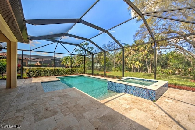 view of pool featuring glass enclosure, an in ground hot tub, and a patio