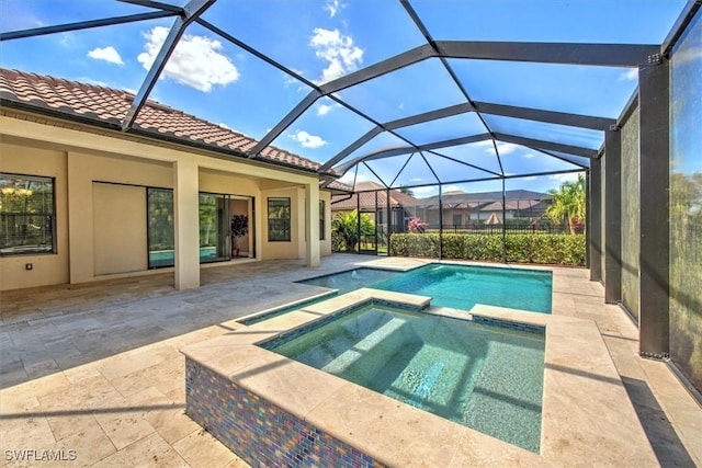 view of swimming pool with an in ground hot tub, a patio, and a lanai