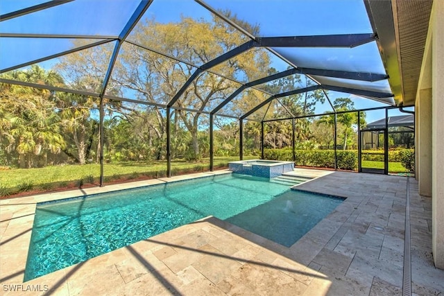 view of pool featuring an in ground hot tub, a lanai, and a patio area