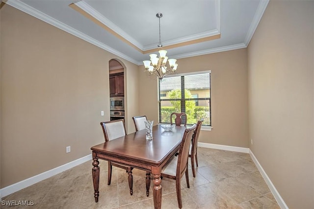 dining room with a chandelier, crown molding, and a tray ceiling