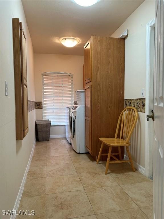 laundry room featuring washing machine and clothes dryer and cabinets