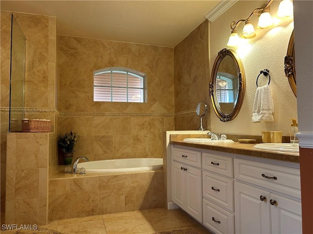 bathroom with vanity, ornamental molding, tiled bath, and tile patterned flooring