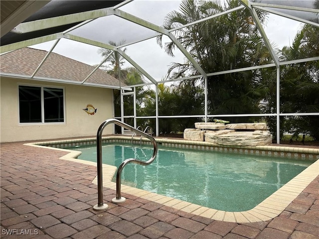 view of pool with a lanai and a patio