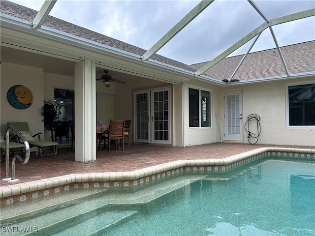 view of pool with ceiling fan, a patio area, french doors, and a lanai