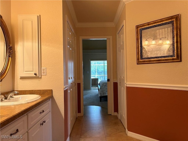 bathroom featuring ornamental molding, tile patterned flooring, and vanity