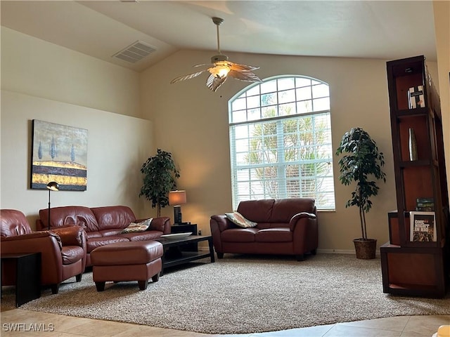 tiled living room featuring plenty of natural light, vaulted ceiling, and ceiling fan