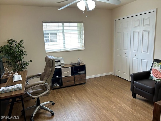 home office featuring light wood-type flooring and ceiling fan