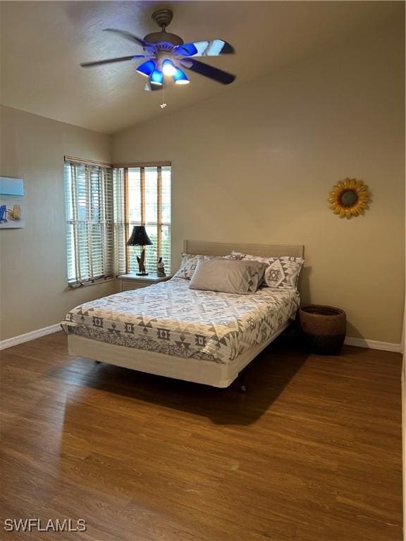 unfurnished bedroom with ceiling fan, dark wood-type flooring, and vaulted ceiling