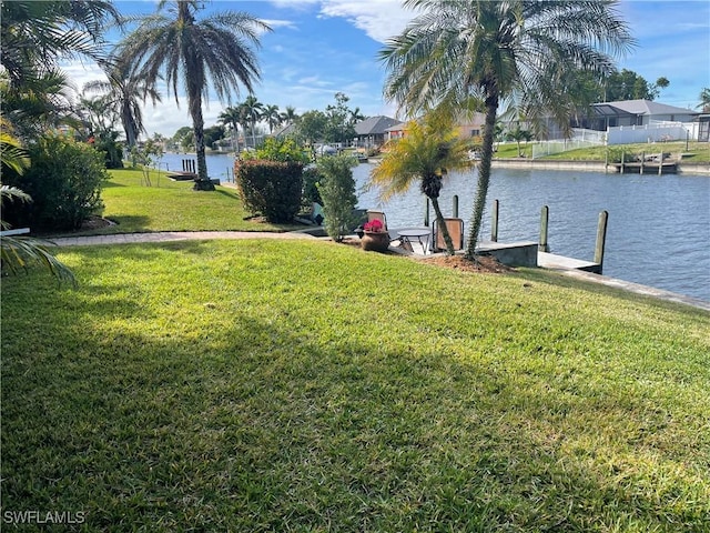 view of yard featuring a boat dock and a water view