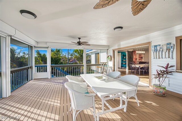 3131 Twin Lakes Ln, Sanibel, FL 33957 - sunroom / solarium featuring outdoor dining space and ceiling fan with notable chandelier