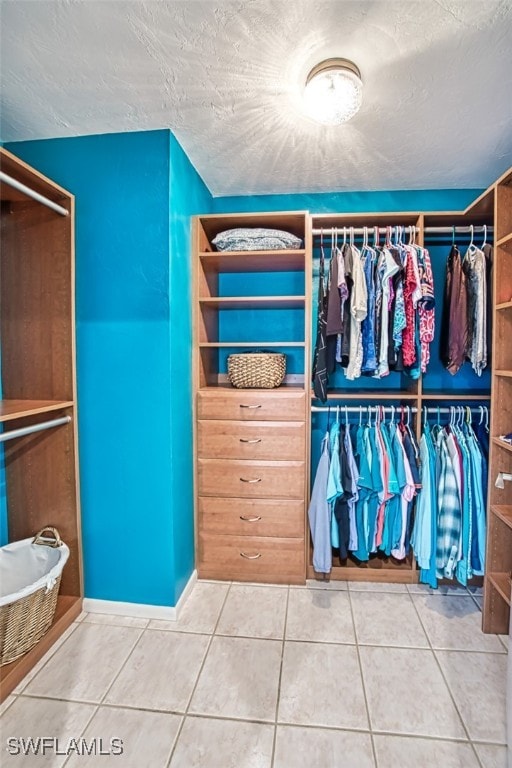 spacious closet with tile patterned floors