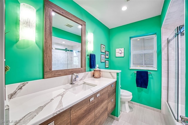 full bathroom with tile patterned floors, toilet, vanity, and combined bath / shower with glass door