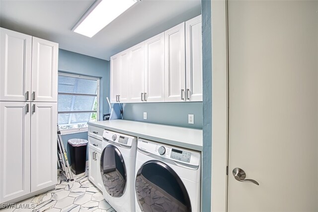 laundry area with cabinets and washer and dryer