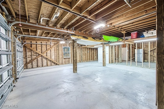 basement featuring stainless steel refrigerator