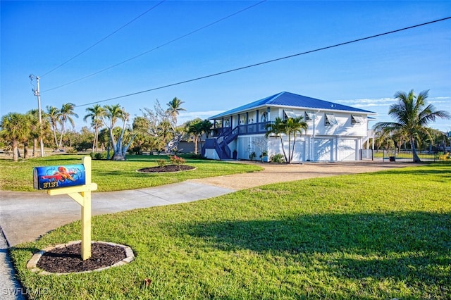 view of front of home with a front yard and a garage