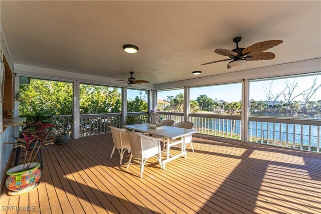3131 Twin Lakes Ln, Sanibel, FL 33957 - sunroom with a water view, ceiling fan, and outdoor dining space
