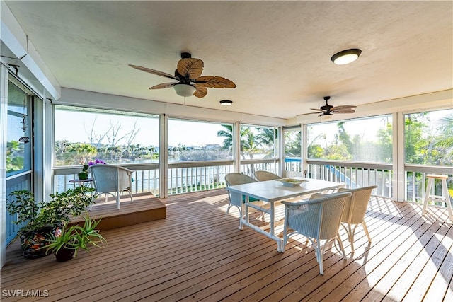 3131 Twin Lakes Ln, Sanibel, FL 33957 - sunroom featuring a water view, outdoor dining space, and a ceiling fan