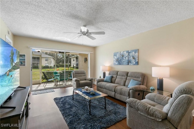 living room with wood-type flooring, a textured ceiling, and ceiling fan