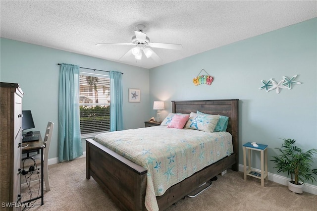 carpeted bedroom with ceiling fan and a textured ceiling