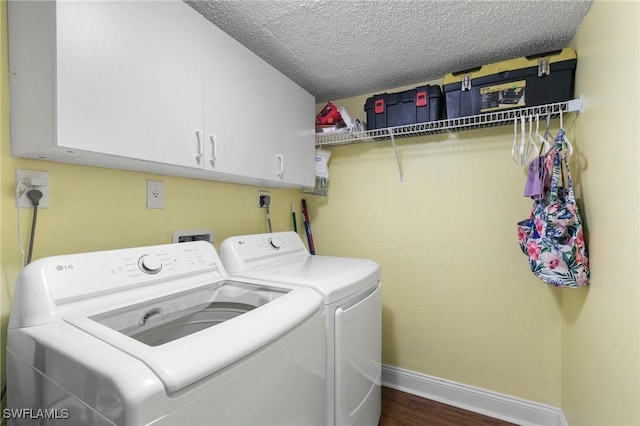 clothes washing area with cabinets, independent washer and dryer, dark wood-type flooring, and a textured ceiling