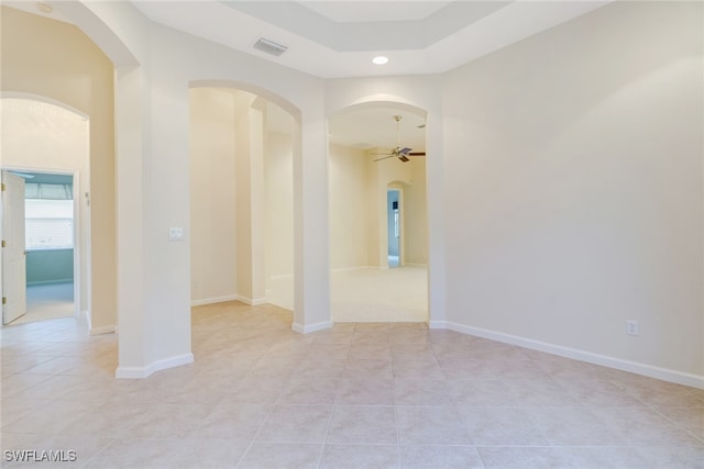 spare room featuring light tile patterned floors and ceiling fan