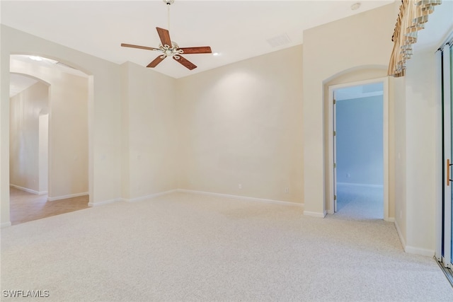 carpeted spare room with ceiling fan