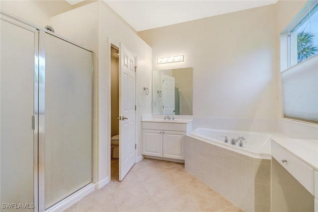 full bathroom featuring vanity, toilet, shower with separate bathtub, and tile patterned floors