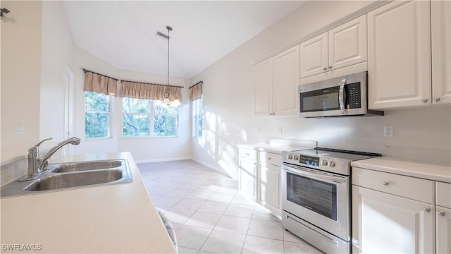 kitchen featuring decorative light fixtures, sink, white cabinetry, and stainless steel appliances